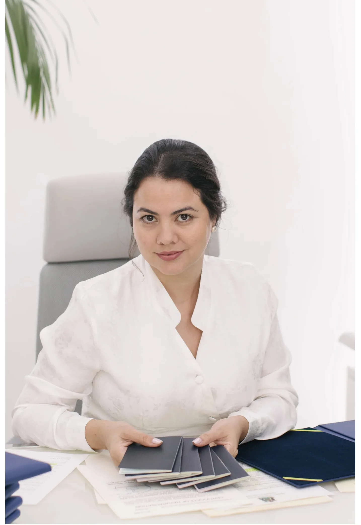 Giselle Bru, Founder of PassPro — portrait alongside the firm's standing.